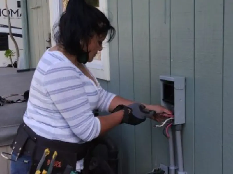 Licensed electrician wiring an exterior subpanel in Summerfield